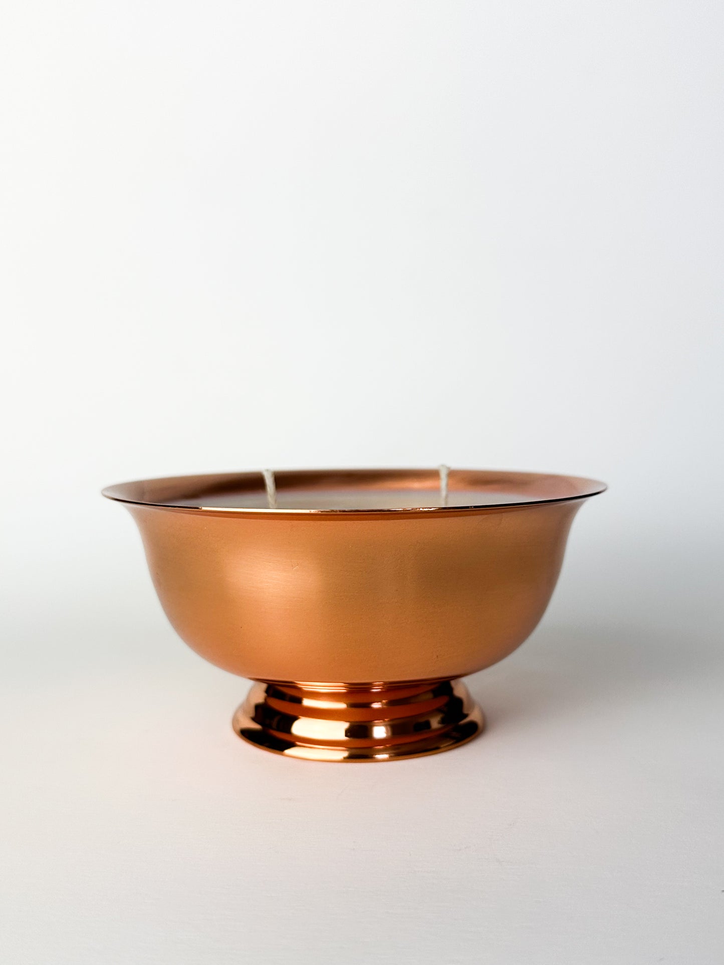 Copper bowl candle on a white background
