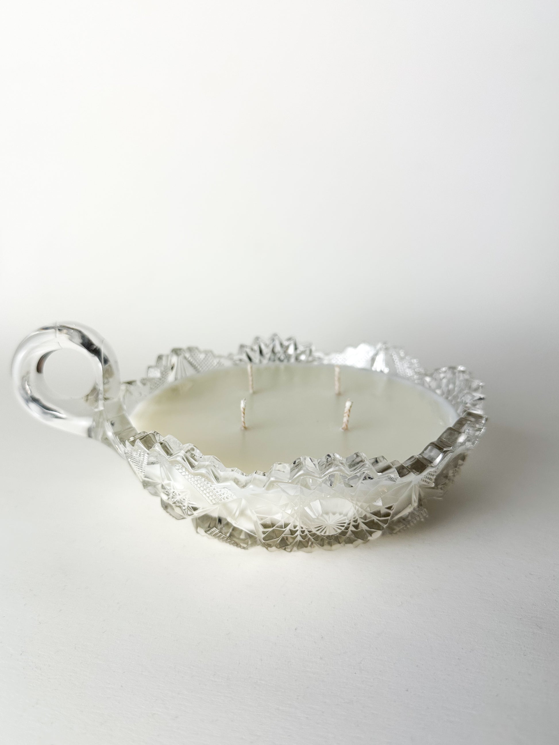 Decorative glass bowl with a candle on a white background