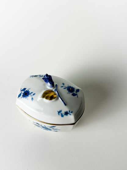 Heart-shaped ceramic box with blue floral patterns on a white background