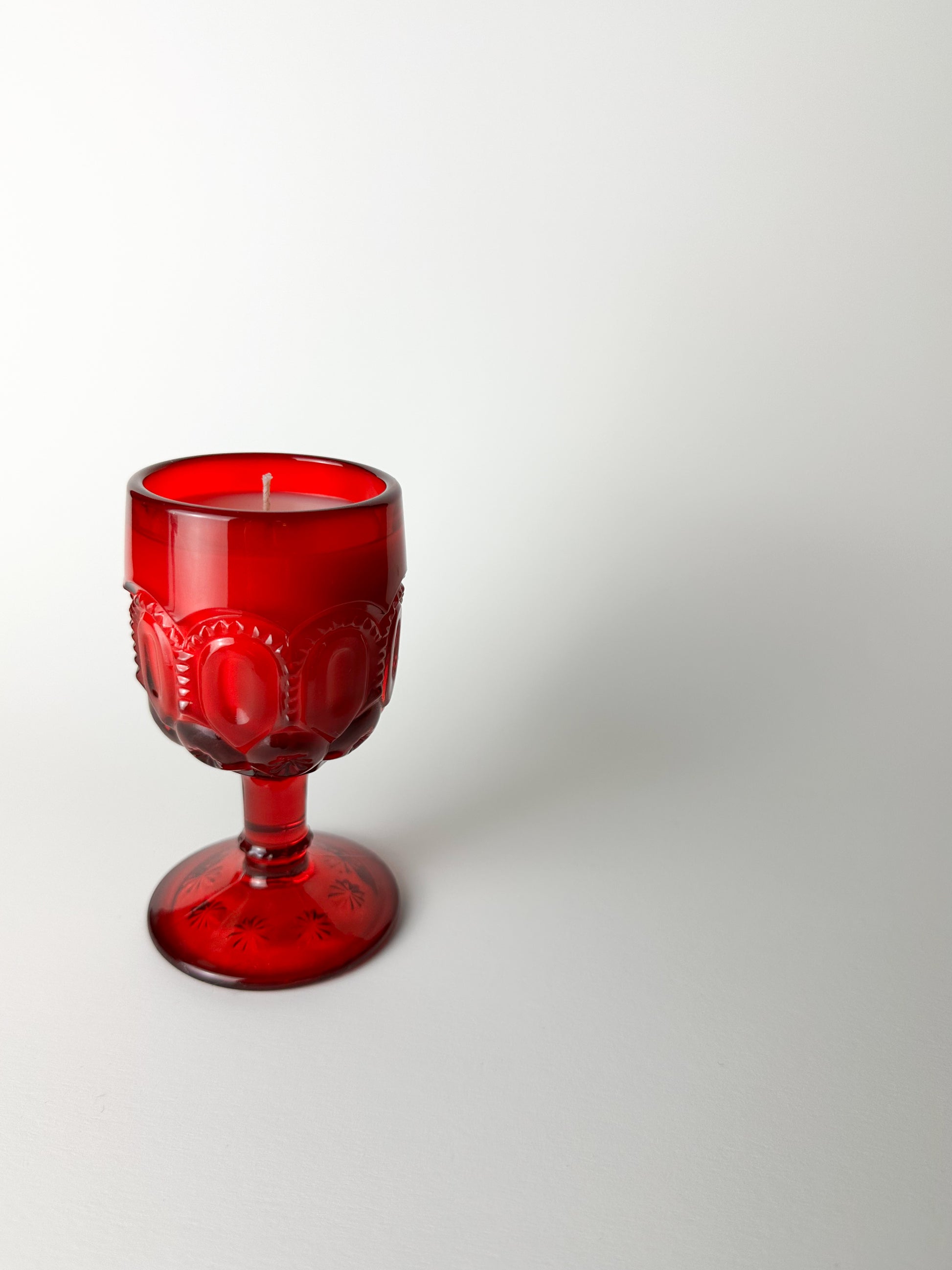 Red glass goblet on a white background