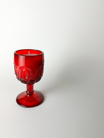 Red glass goblet on a white background
