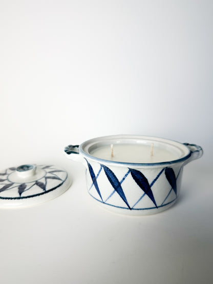 Ceramic container with a lid featuring blue geometric patterns on a white background