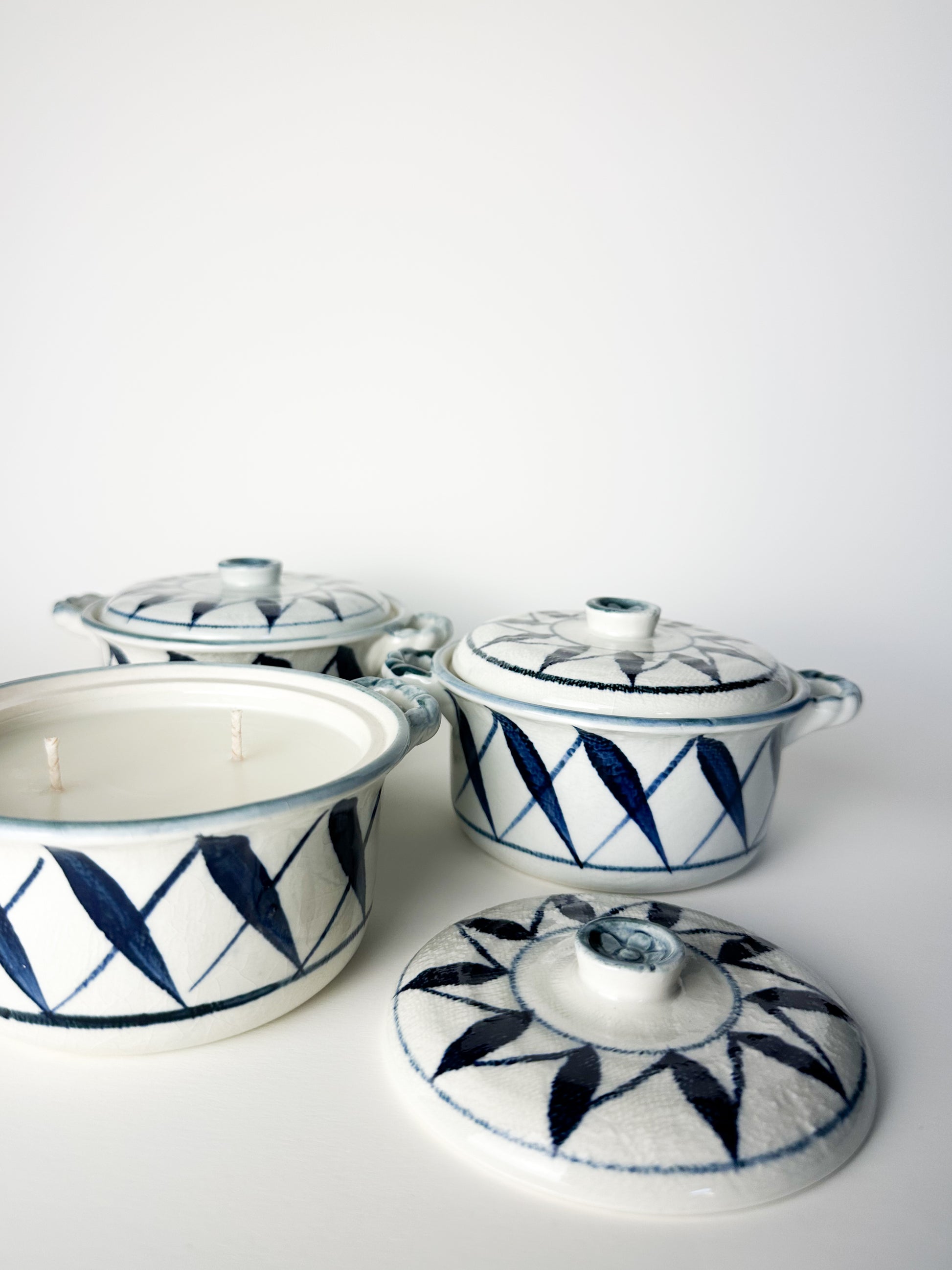 Set of ceramic containers with blue geometric patterns on a white background