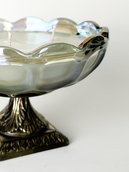 Decorative glass bowl with a metallic base on a white background