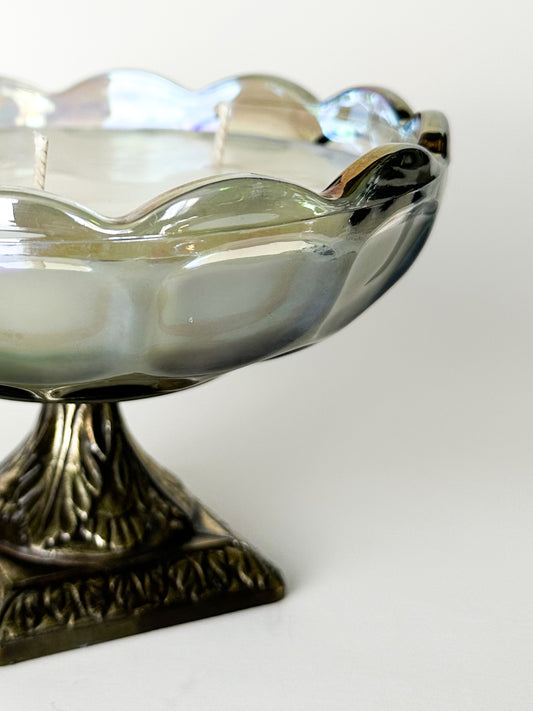 Decorative glass bowl with a metallic base on a white background