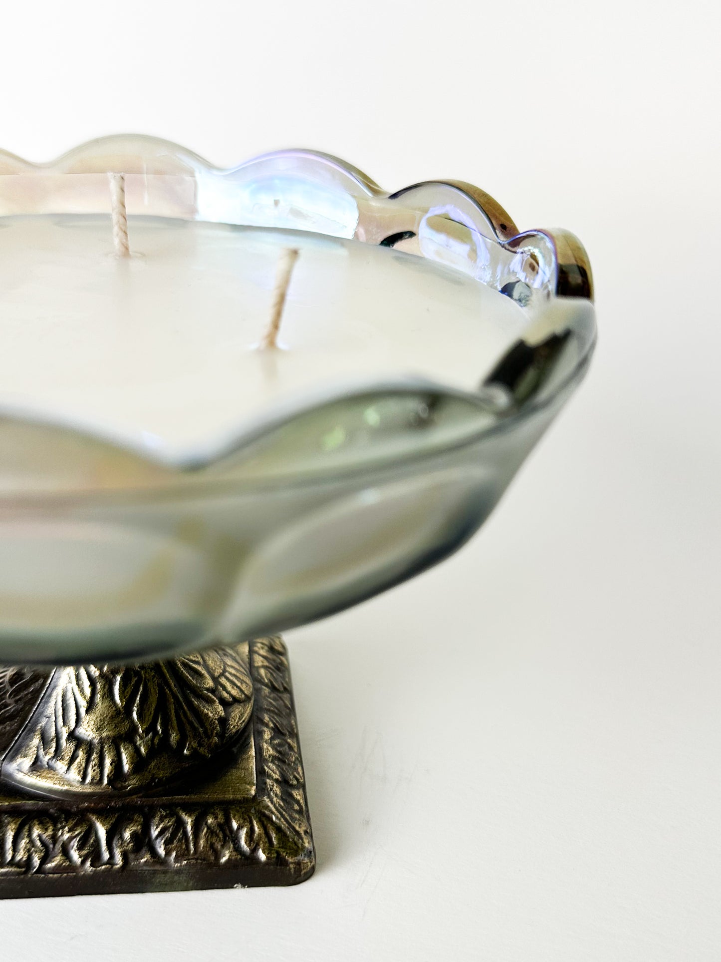 Decorative candle holder with a candle inside on a white background
