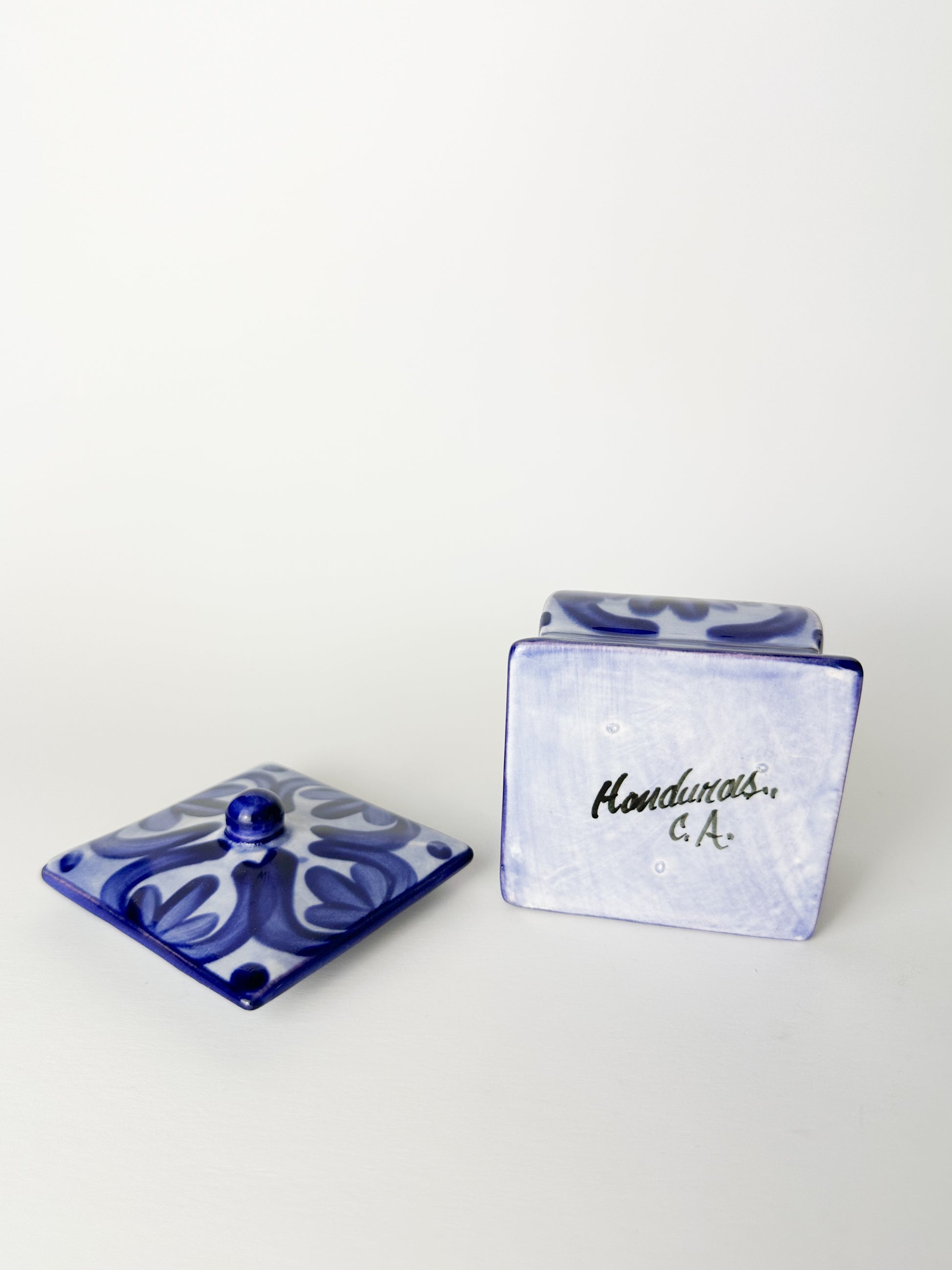 Blue ceramic container with lid on a white background