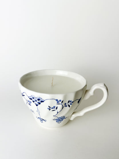 Ceramic cup with blue floral design on a white background