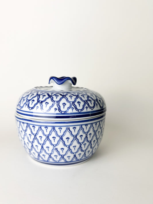 Ceramic jar with blue and white pattern on a white background